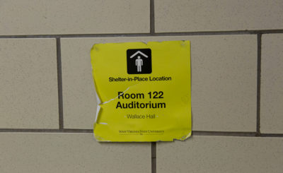 Shelter-in-place sign on a wall in Wallace Hall
